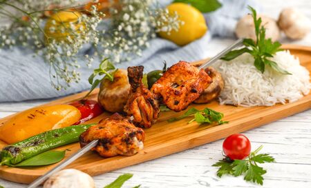skewered chicken kebab with rice and vegetablesの写真素材