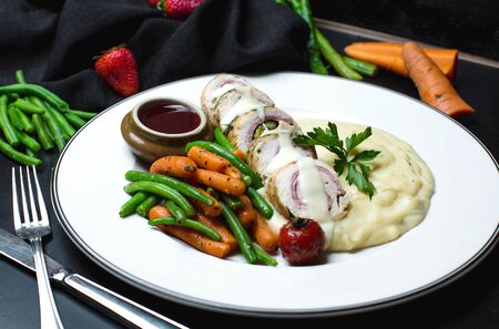 chicken roll in a creamy sauce with vegetablesの写真素材