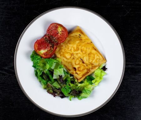 fried pancake with tomato and herbs