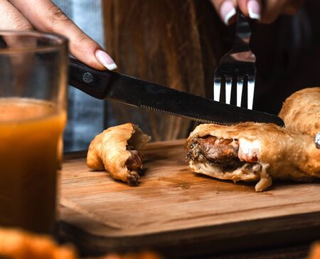 fried meat in the dough on wooden boardの写真素材