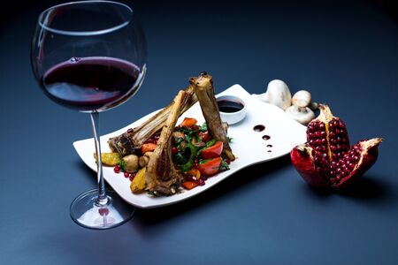 lamb ribs kebab with grilled vegetables, served with red wine