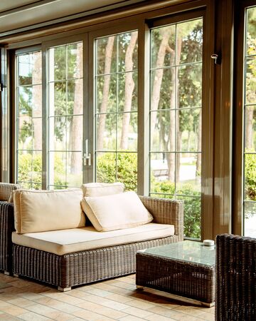 outdoor sofa with beige cushions and coffee table in front