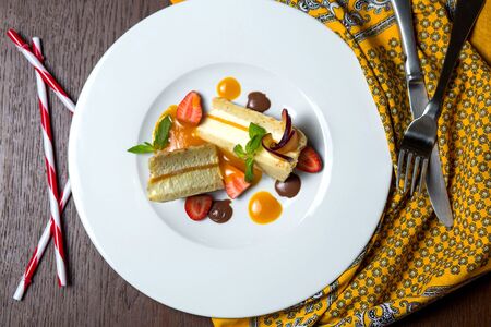apricot cake served with strawberry, plum and sauce