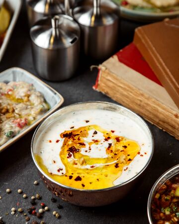 sour cream topped with oil and dried red pepperの写真素材