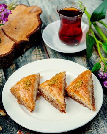 turkish baklava with nuts and a cup of hot teaの写真素材