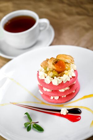 pink macaroons with fruit  cream on itの写真素材