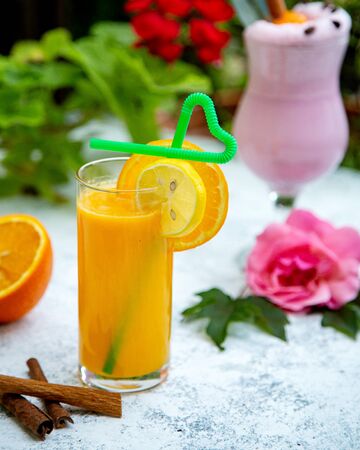 orange juice with a slice of orange and lemonの写真素材