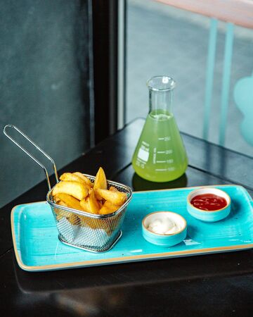 fried potato with ketchup and juice _