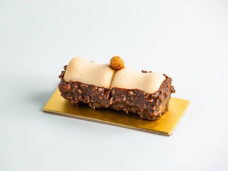 delicious cookie half dipped into chocolate with hazelnuts