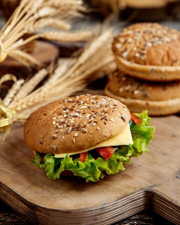 delicious sandwich with lettuce cheese tomato and bread with seedsの写真素材