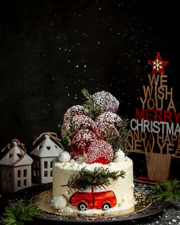 new year themed cake with red car illustration and pineの写真素材