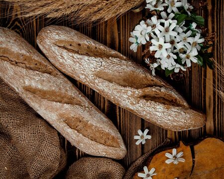 top view of brown bread baguettes on wooden table
