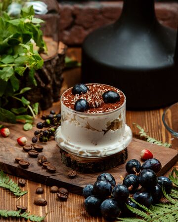 fruit dessert with cream and sprinkled with cocoaの写真素材