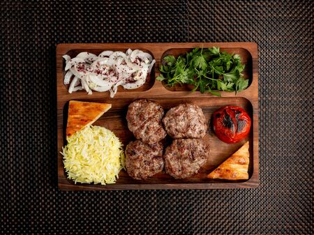 meat patties with rice onions herbs and fried pomの写真素材