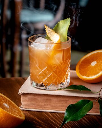 orange cocktail with ice on the tableの写真素材