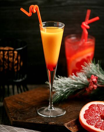 orange grapefruit mix cocktail on the tableの写真素材