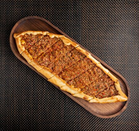 pide with stuffed meat and hot pepper on a woodenの写真素材