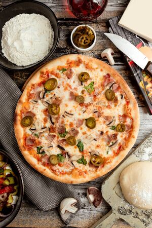 pizza with mushroom and ham on the tableの写真素材