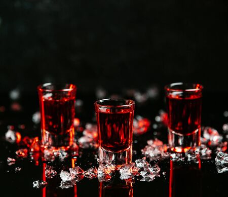 shots with red drinks on the tableの写真素材
