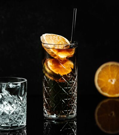 soda in black glass with lemon sliceの写真素材