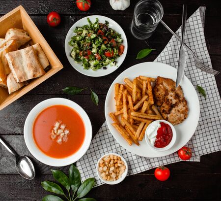 tomato soup, vegetable salad and chicken with french friesの写真素材