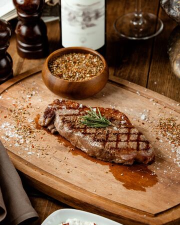 fried rib eye steak on wooden boardの写真素材
