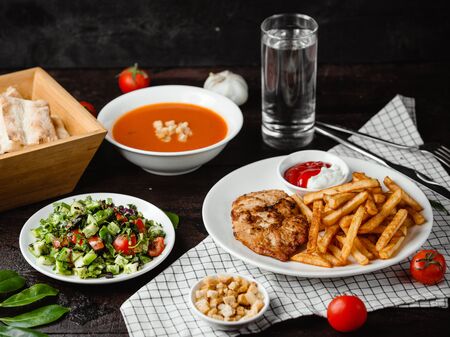tomato soup, vegetable salad and chicken with french friesの写真素材