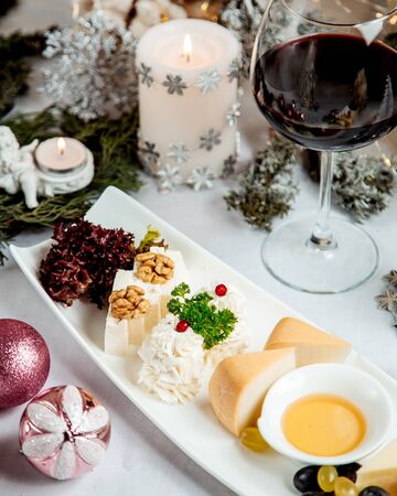 cheese plate with walnuts and glass of wineの写真素材