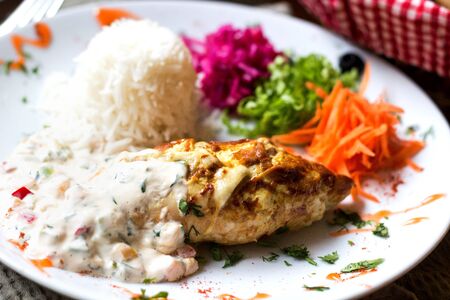 chicken cutlet in sauce with rice
