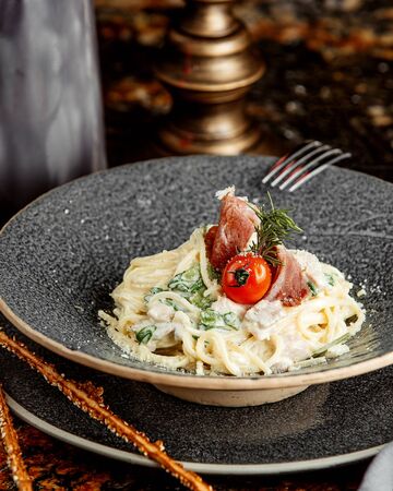 cheese pasta topped with hamの写真素材