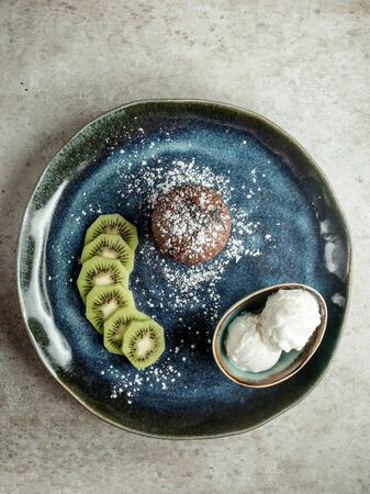 chocolate cookie with sliced kiwi and ice creamの写真素材