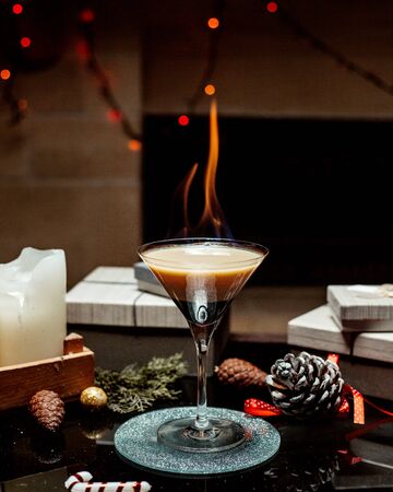 cocktail with mixed layer on fireの写真素材