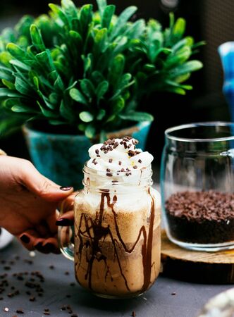 coffee drink with whipped cream and coffee beansの写真素材