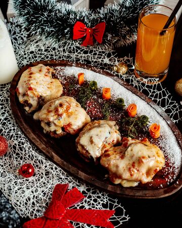 cutlets topped with melted cheese and tomatoの写真素材
