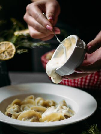 dumplings toppped with sour creamの写真素材