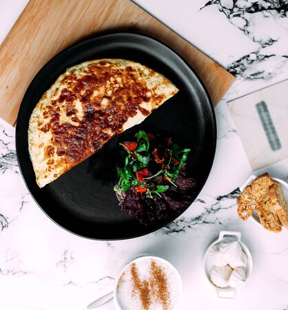 fried eggs in pan with chopped herbsの写真素材