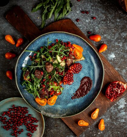 fried meat with herbs and pomegranateの写真素材