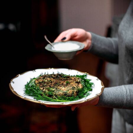 fried eggs with herbs and sour yogurtの写真素材