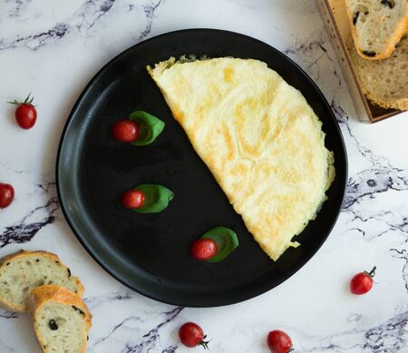 fried eggs with sliced cherry tomatoの写真素材