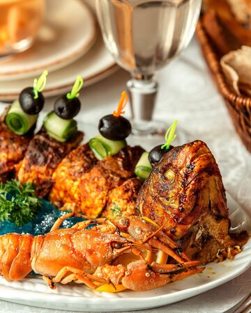 fried fish slices with cucumber and oliveの写真素材