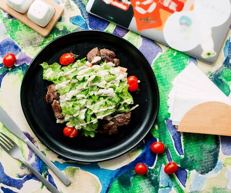 fried meat pieces topped with saladの写真素材