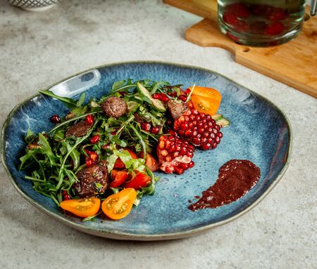 fried meat with herbs and pomegranateの写真素材