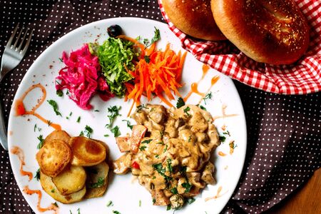 fried mushrooms in sauce with fried potatoesの写真素材
