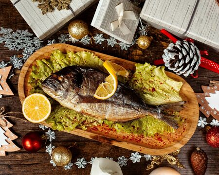 fried fish topped with pepper and lemon slices