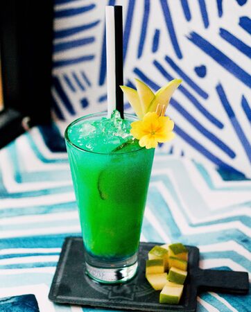 green juice with crushed ice and side apple slicesの写真素材