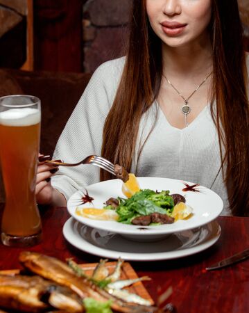 meat slices and lemon with beerの写真素材