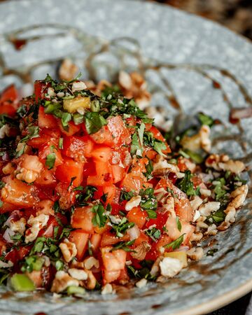 mixed salad with chopped tomato and herbsの写真素材