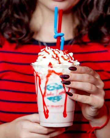 milkshake with whipped cream and fruit syrupの写真素材