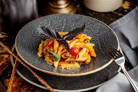 pasta with cheese topped with basilの写真素材