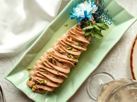 sliced fish topped with pistachioの写真素材